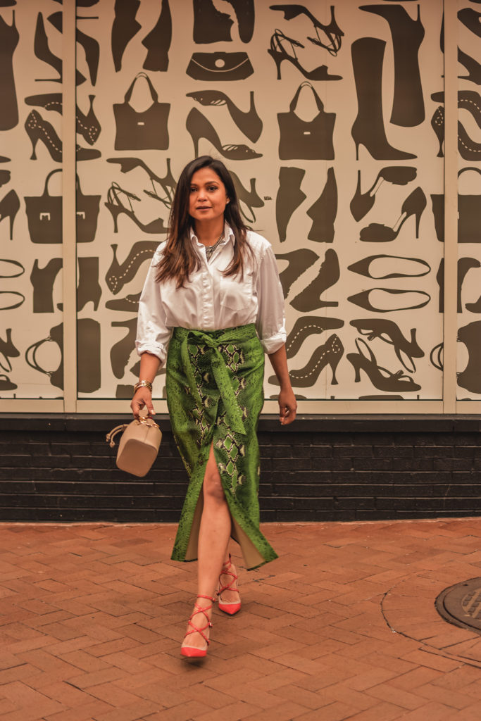 I am wearing a python print green leather skirt with a white blouse, citrus Valentino pumps and carrying a fendi bucket bag. Im talking about ways to transition your closet from winter to spring. myriad musings, saumya shiohare 