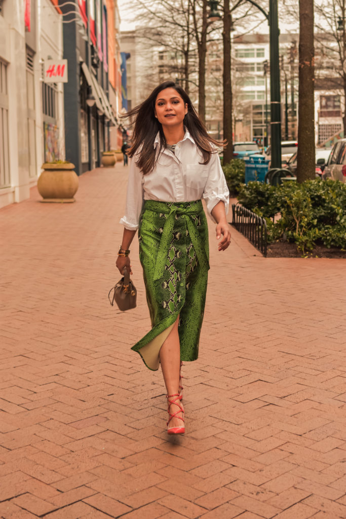 I am wearing a python print green leather skirt with a white blouse, citrus Valentino pumps and carrying a fendi bucket bag. Im talking about ways to transition your closet from winter to spring. myriad musings, saumya shiohare 