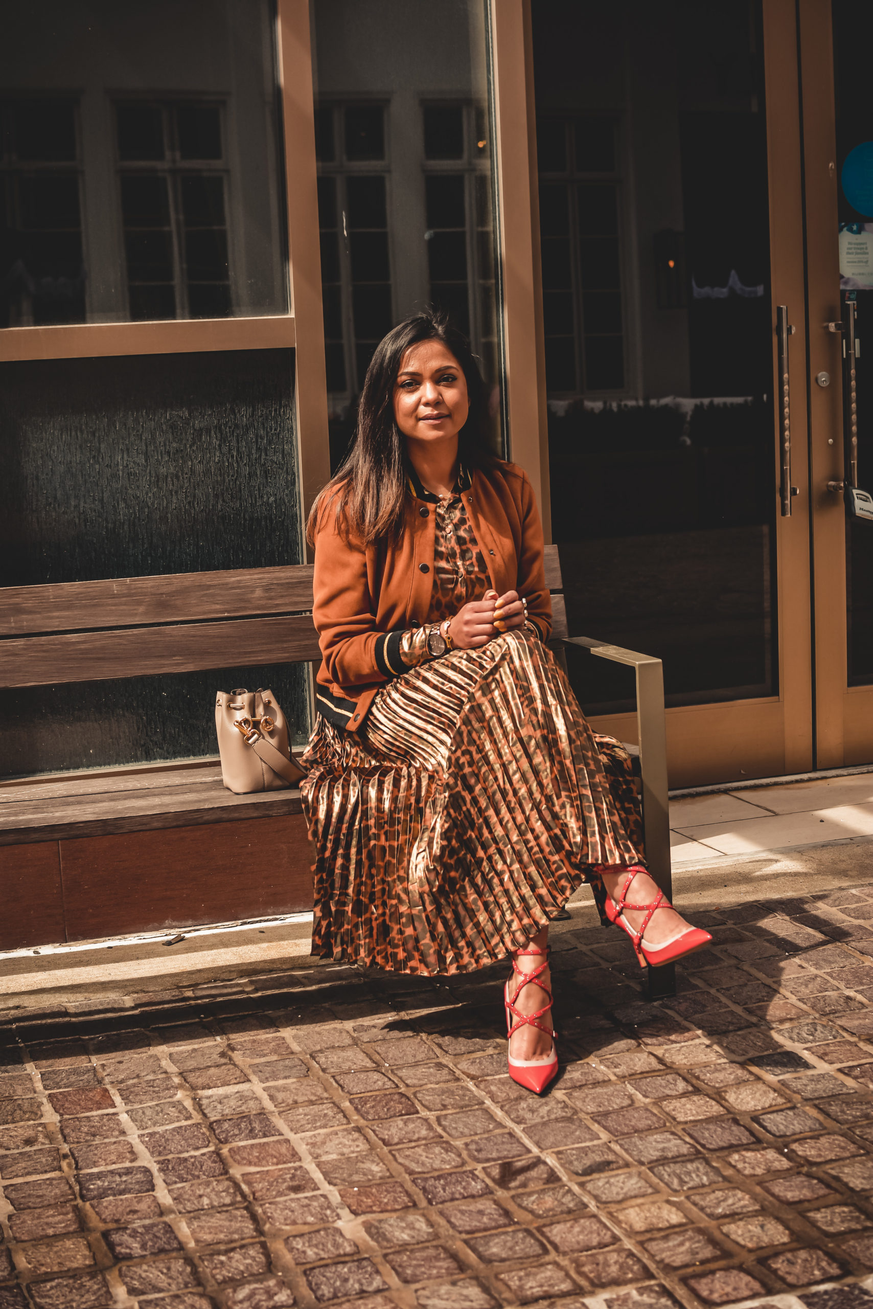 I am wearing a metallic leopard shirt with a metallic leopard skirt from J crew. I paired that with a. pair of orange Valentino heels, Ferragamo gancini belt in brown and a fendi bucket bag. Street style, myriad musings, how to wear leopard on leopard. print mixing 