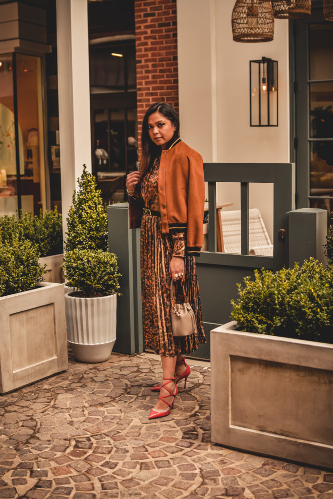 I am wearing a metallic leopard shirt with a metallic leopard skirt from J crew. I paired that with a. pair of orange Valentino heels, Ferragamo gancini belt in brown and a fendi bucket bag. Street style, myriad musings, how to wear leopard on leopard. print mixing 