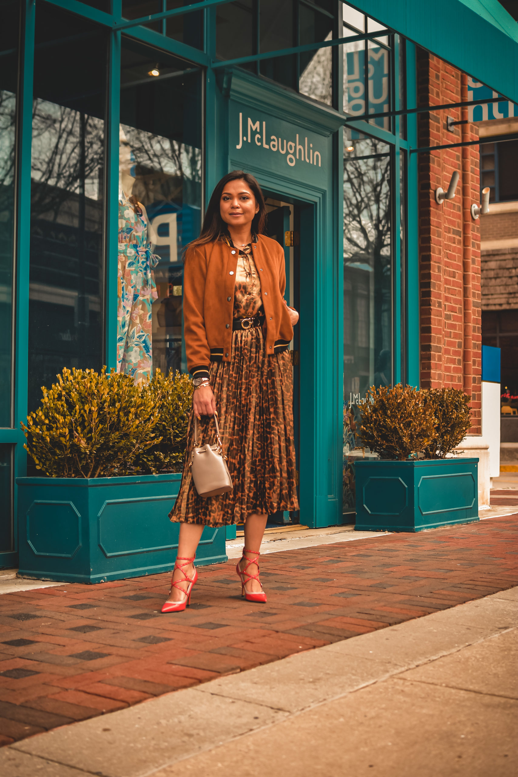 I am wearing a metallic leopard shirt with a metallic leopard skirt from J crew. I paired that with a. pair of orange Valentino heels, Ferragamo gancini belt in brown and a fendi bucket bag. Street style, myriad musings, how to wear leopard on leopard. print mixing 