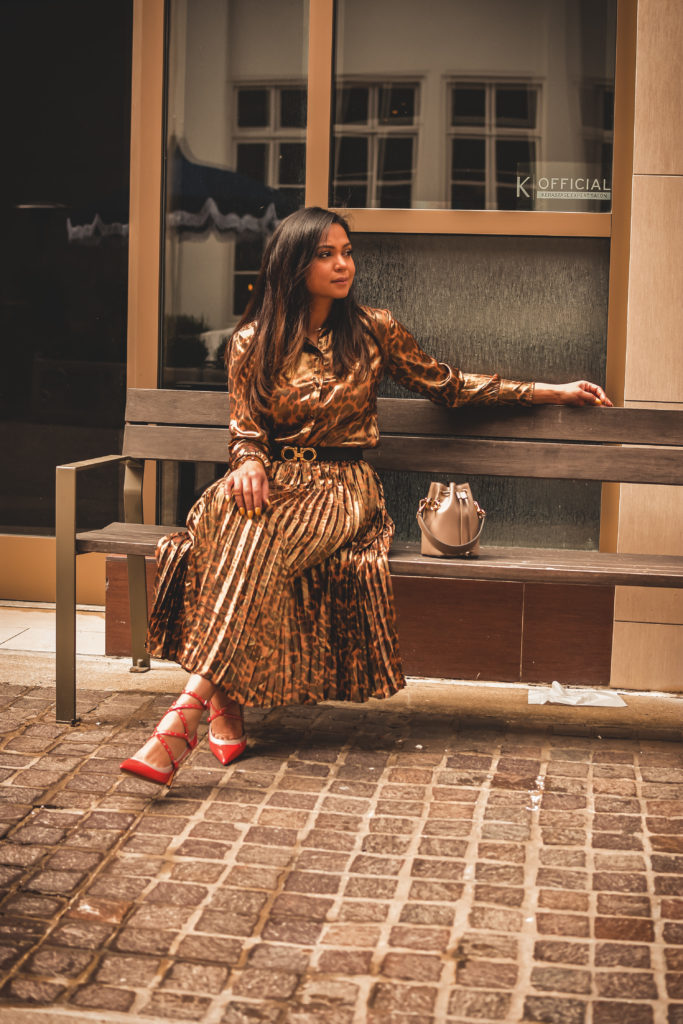 I am wearing a metallic leopard shirt with a metallic leopard skirt from J crew. I paired that with a. pair of orange Valentino heels, Ferragamo gancini belt in brown and a fendi bucket bag. Street style, myriad musings, how to wear leopard on leopard. print mixing 