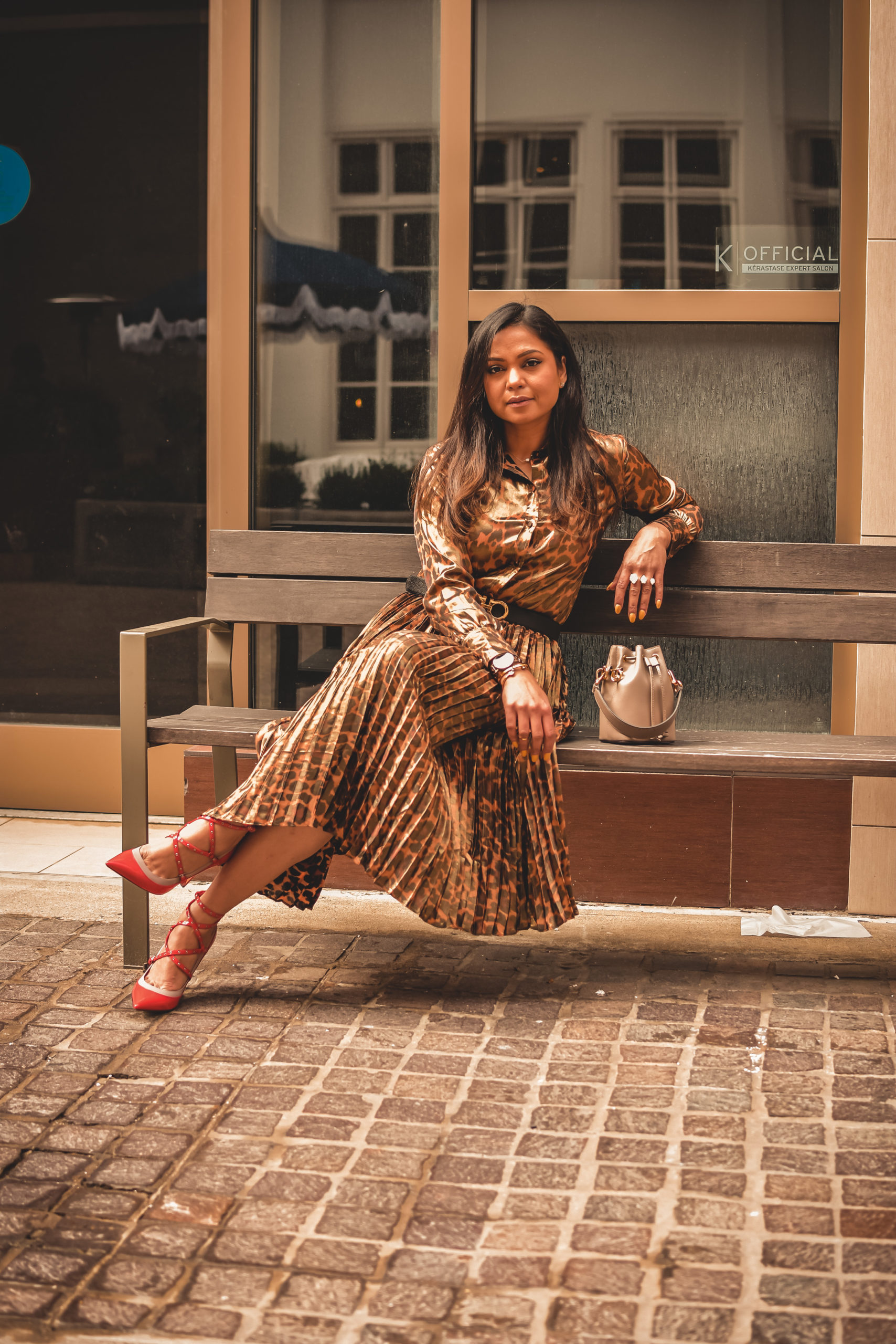 I am wearing a metallic leopard shirt with a metallic leopard skirt from J crew. I paired that with a. pair of orange Valentino heels, Ferragamo gancini belt in brown and a fendi bucket bag. Street style, myriad musings, how to wear leopard on leopard. print mixing 